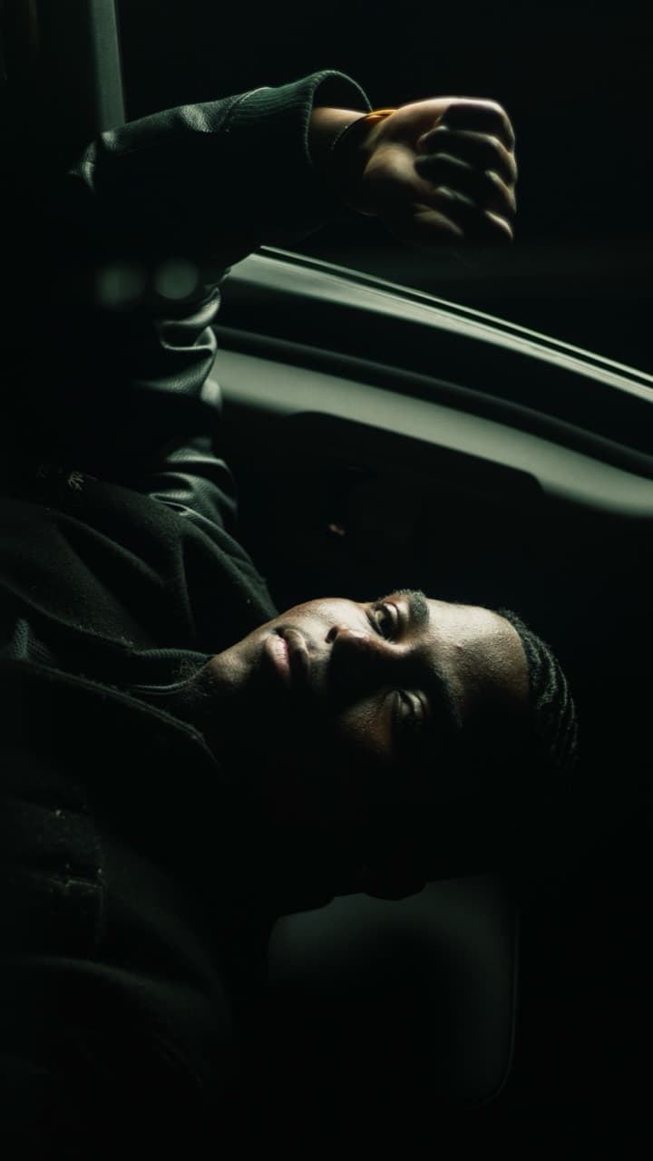 Low-light editorial portrait inside a car